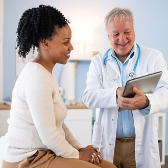 Woman with a chronic illness smiles as her doctor shares treatment options.