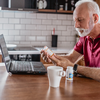 A man using his computer to review income risks to consider when retirement planning