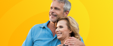 A retired couple smiling.