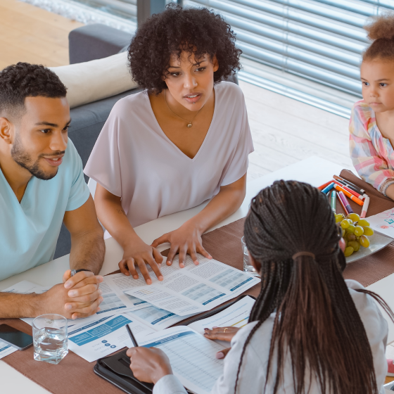 A financial professional discussing the optional benefits available on Protective ProClassic Legacy UL with a young family.