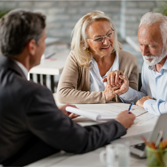 Older couple planning their retirement with a financial planner, learning about Protective® Dimensions V variable annuity
