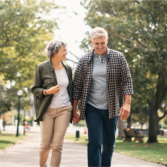 Retired couple walking and smiling, knowing their retirement goals are protected by a Protective Dimensions V variable annuity.