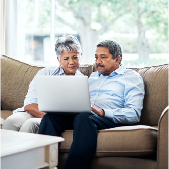 couple reviewing the SecurePay Income℠ benefit's investment choices on their laptop.