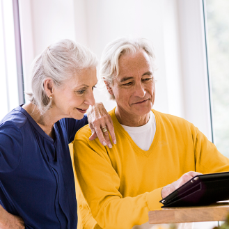 Husband and wife reviewing information about a variable annuity that fits their risk-tolerance, growth-focused retirement savings objectives.