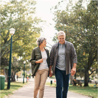 A couple, who represent potential Protective Dimensions IV variable annuity clients, enjoying a walk during their retirement. 