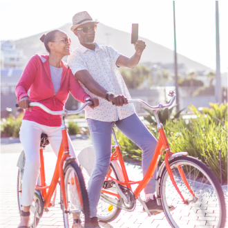 Couple pauses during a bike ride to take a selfie happy knowing their Protective Income Creator Fixed Annuity