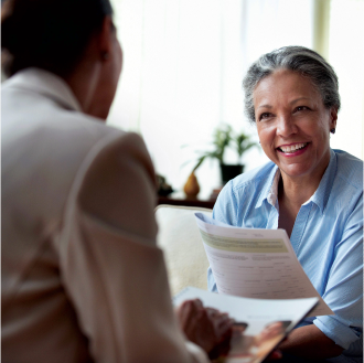 A woman smiling while meeting with her financial professional about Medicare