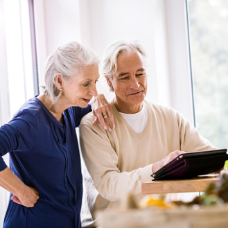 Husband and wife reviewing information about a variable annuity that fits their risk-tolerance, growth-focused retirement savings objectives