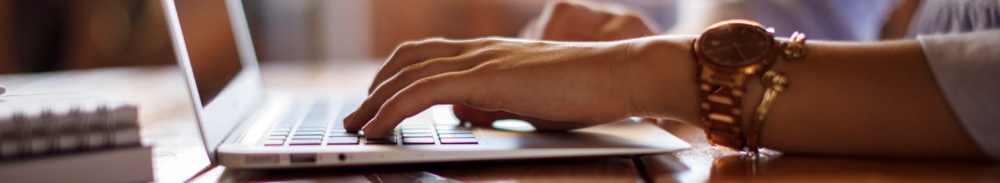 Hands on keyboard accessing educational resources.