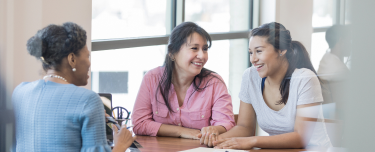A financial professional meeting with a mother and daughter