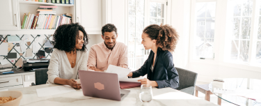 Three people discussing life insurance options. 