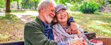 Happy couple enjoying a secure retirement with a solid guaranteed income plan. 