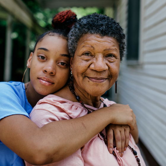 A grandmother looking content knowing her granddaughter's future is protected by the Secure Saver fixed annuity.